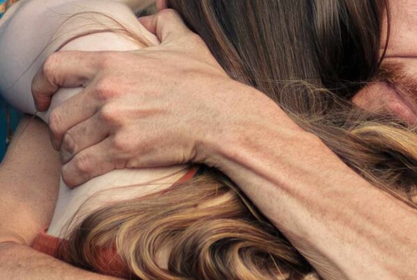 A couple embrace showing how the camera captures a moment and defies time